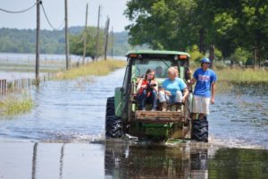 During the first round of historic flooding, I had to ride on a tractor with this family to reach their flooded home. 